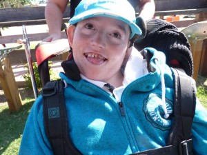 Boy with disabilities in blue sweat and cap